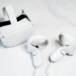 a pair of white vr headsets and controllers