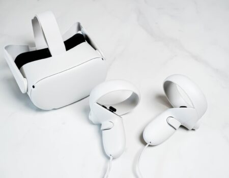 a pair of white vr headsets and controllers